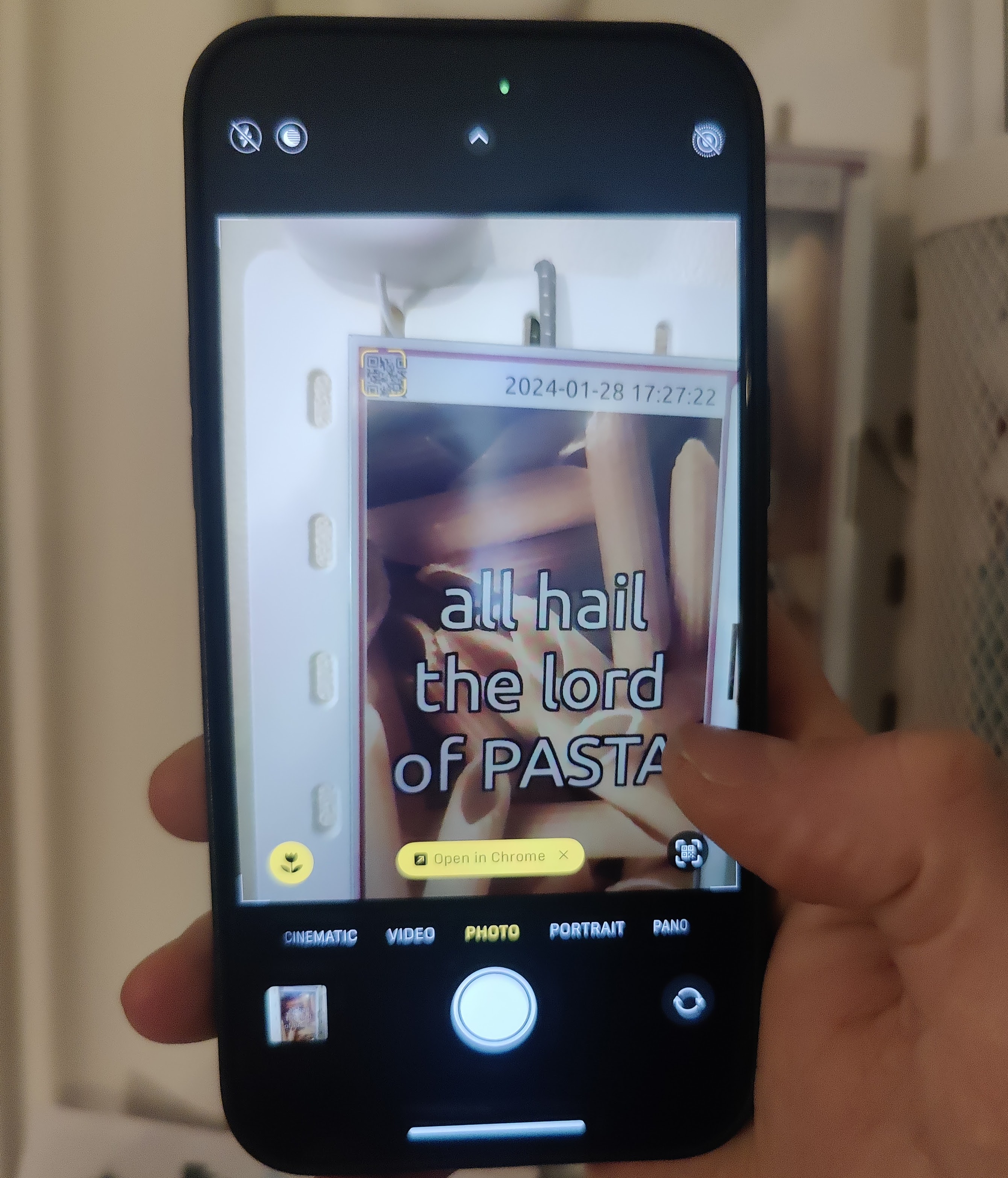 Phone scanning the QR code shown on a frame to control it
